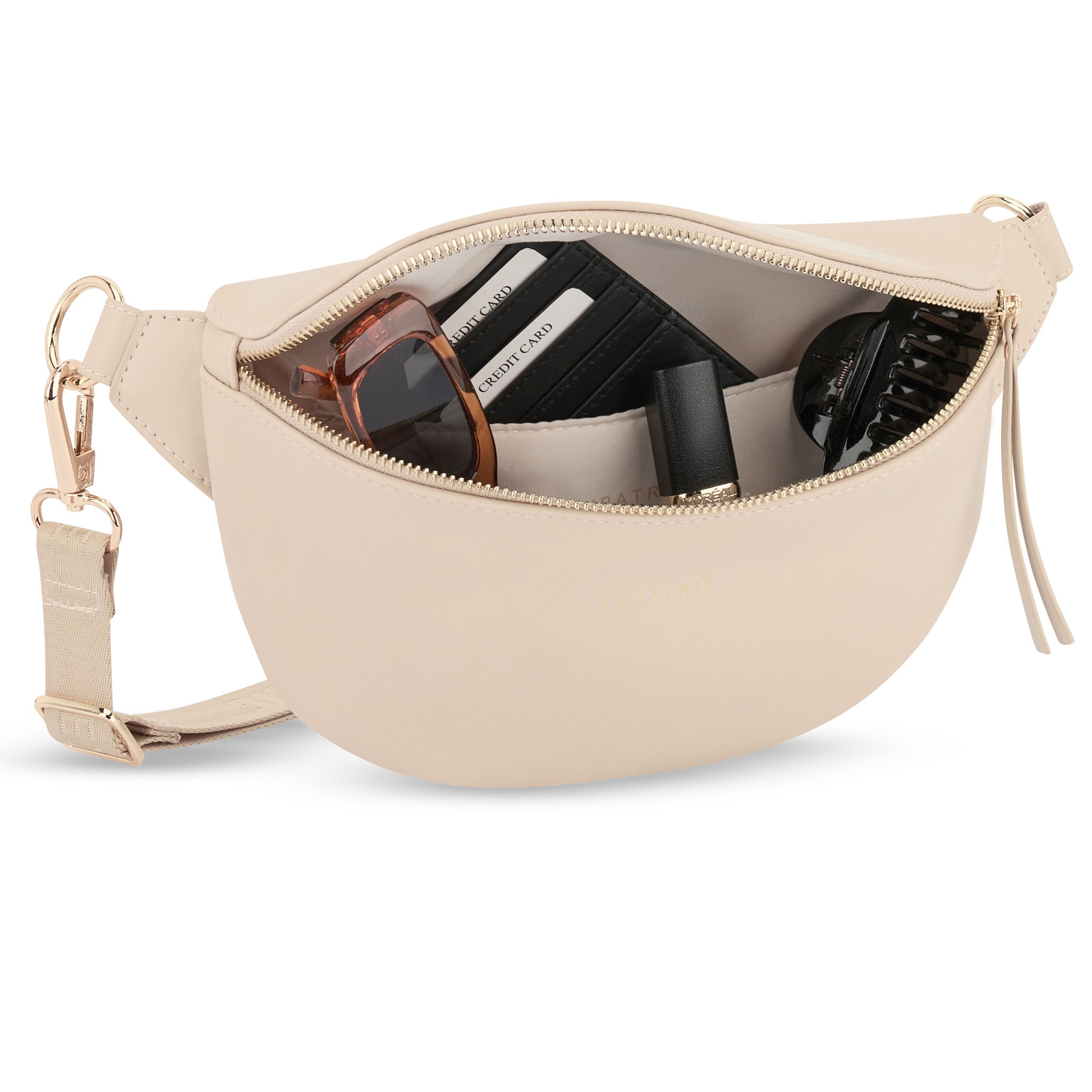 Beige Bauchtasche Alice Small aus Leder mit geöffnetem Reißverschluss und Sonnenbrille, Kreditkartenfach, Lippenstift und Haarklammer innen