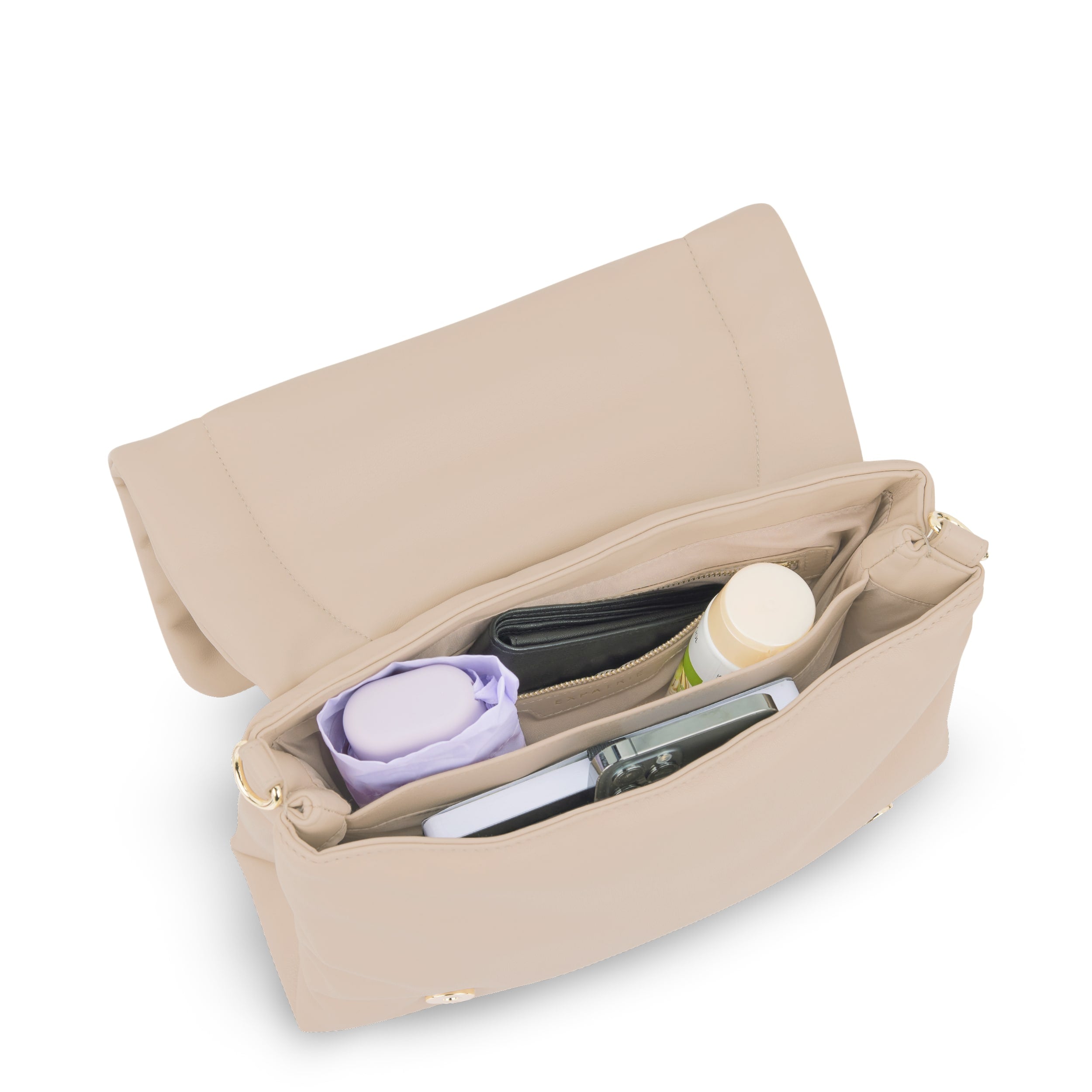 Beige Umhängetasche Zoe Medium mit geöffneter Klappe, darin ein Portemonnaie, ein Smartphone, eine Dose und ein lila Tuch