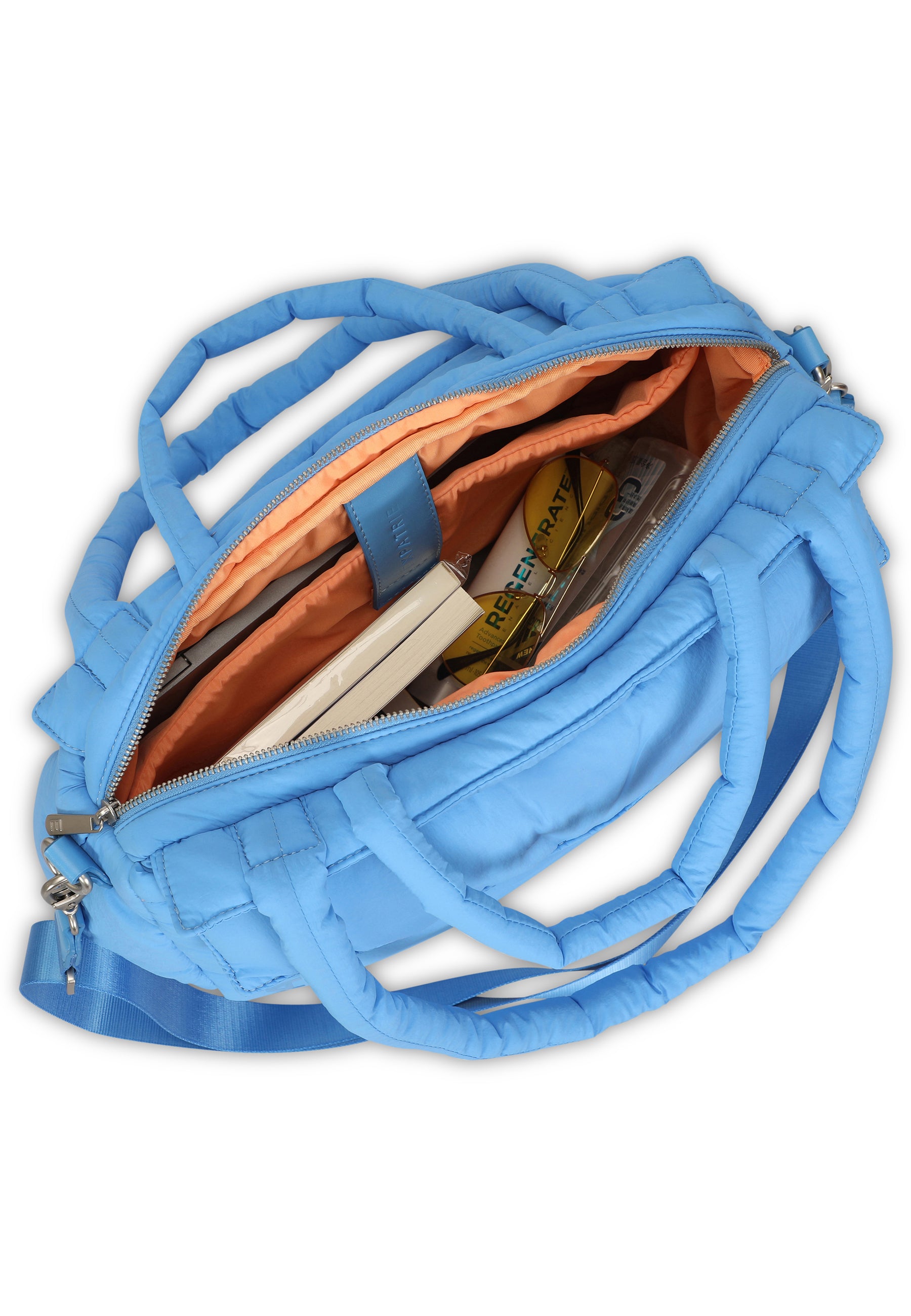 Große, royalblaue Poppy Shopper Tasche aus gepolstertem Material, Innenraum orange mit mehreren Fächern mit Gegenständen gefüllt